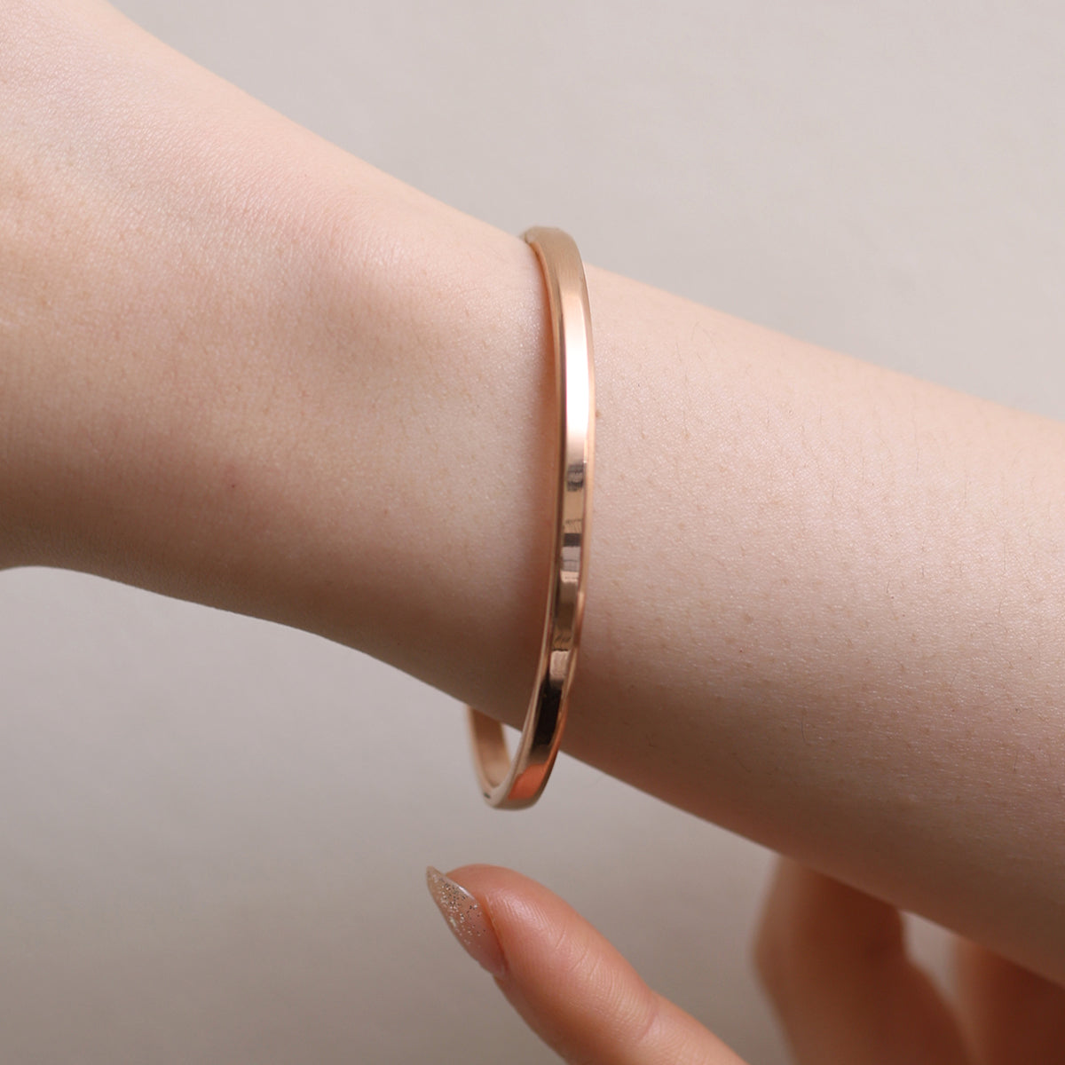 Thin Bangle featuring a precision-crafted, minimalist design with a slender profile, offering versatile style and durable elegance for any occasion.
