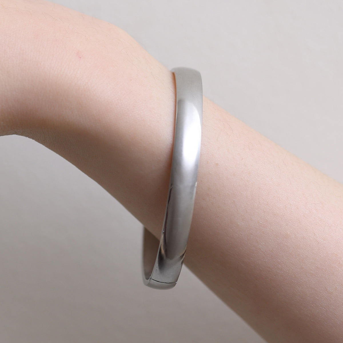 Thick Minimalist Bangle featuring clean lines and a robust profile, expertly crafted for durability and elegance—perfect for elevating both casual and formal looks.