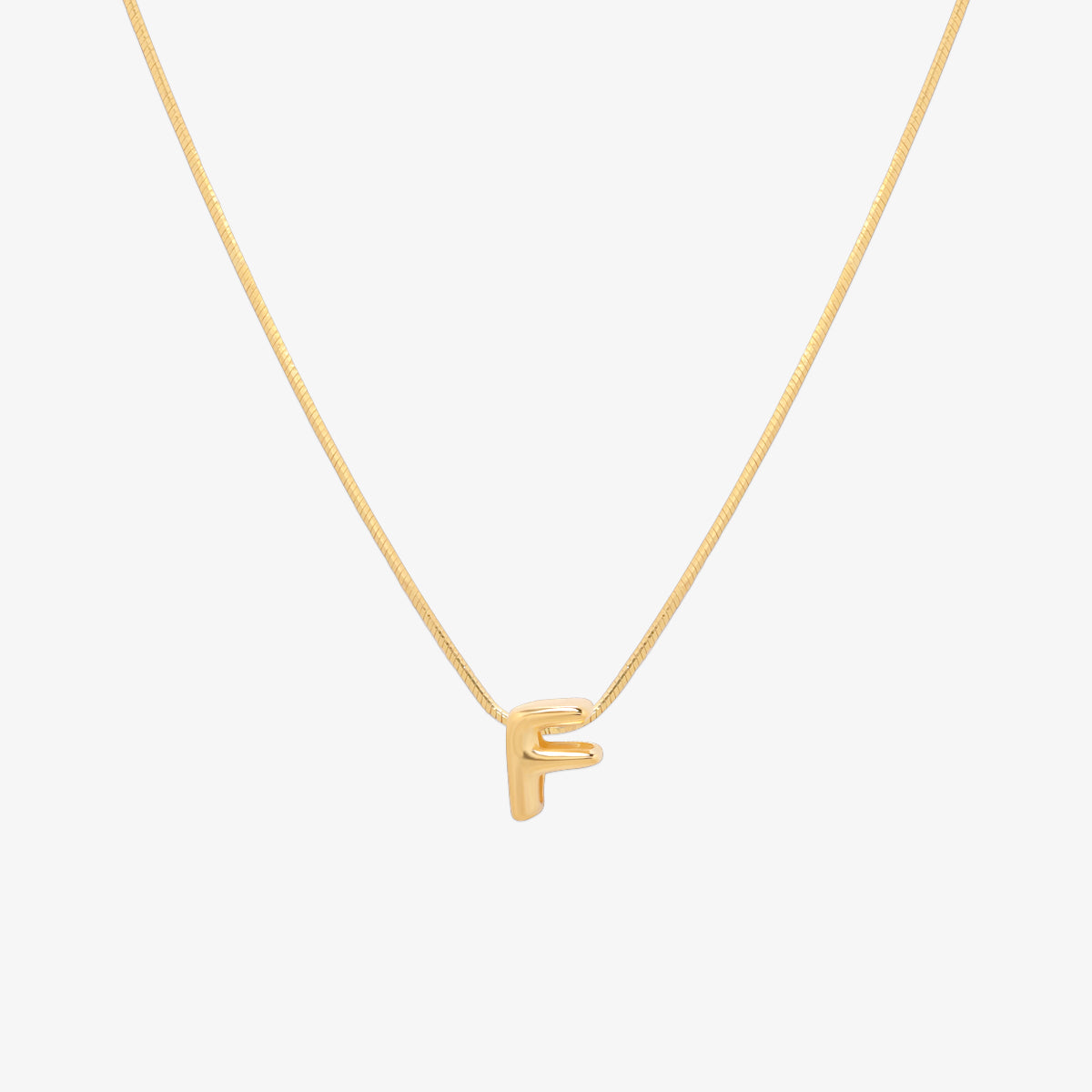 Bubble initial pendant necklace featuring a rounded, playful letter charm on a sleek snake chain, with a smooth and glossy finish.