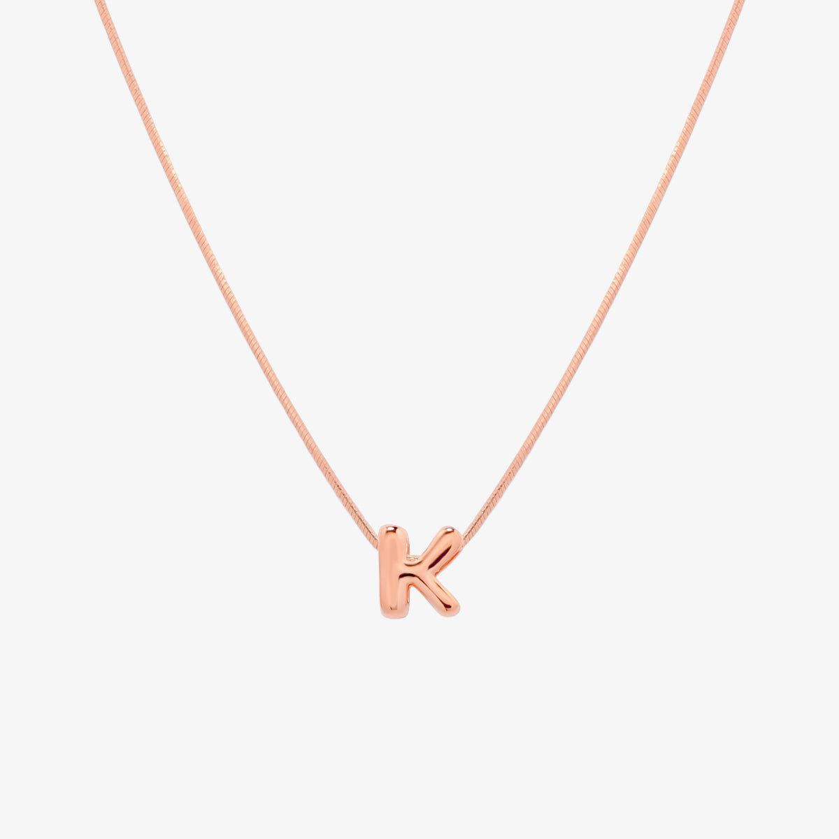 Bubble initial pendant necklace featuring a rounded, playful letter charm on a sleek snake chain, with a smooth and glossy finish.