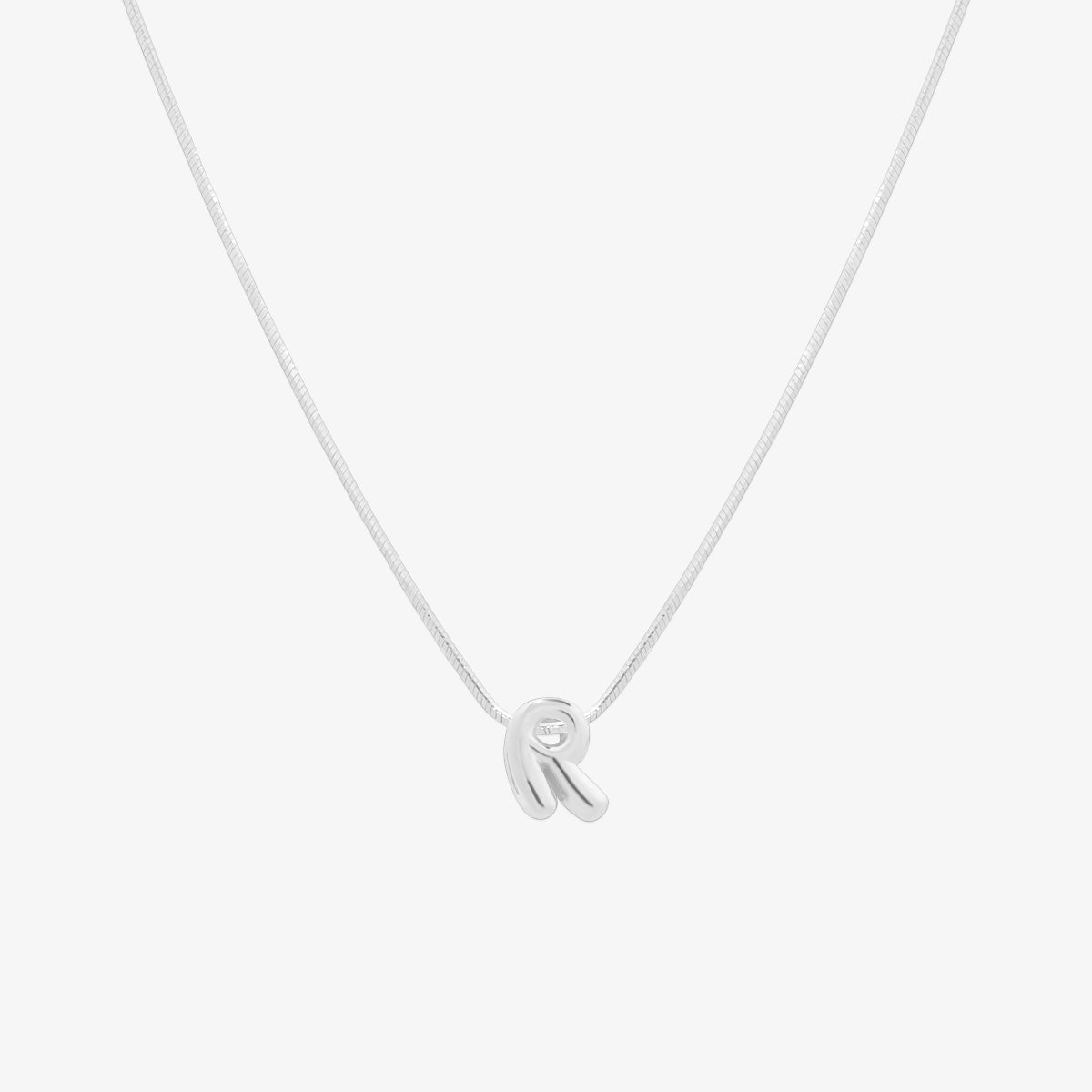 Bubble initial pendant necklace featuring a rounded, playful letter charm on a sleek snake chain, with a smooth and glossy finish.