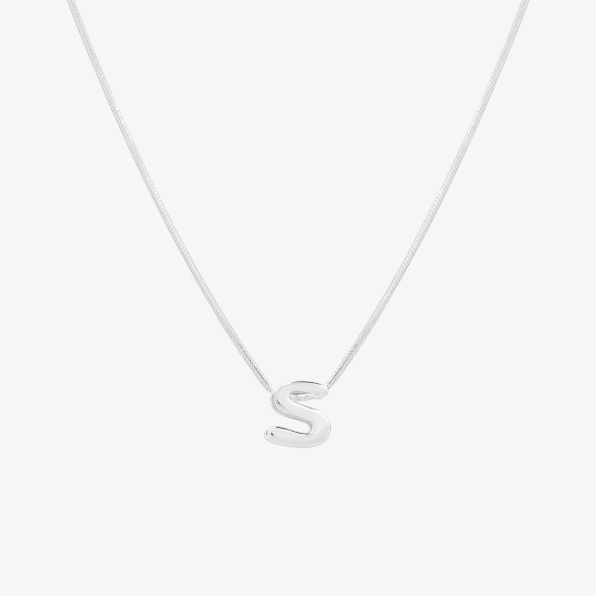 Bubble initial pendant necklace featuring a rounded, playful letter charm on a sleek snake chain, with a smooth and glossy finish.