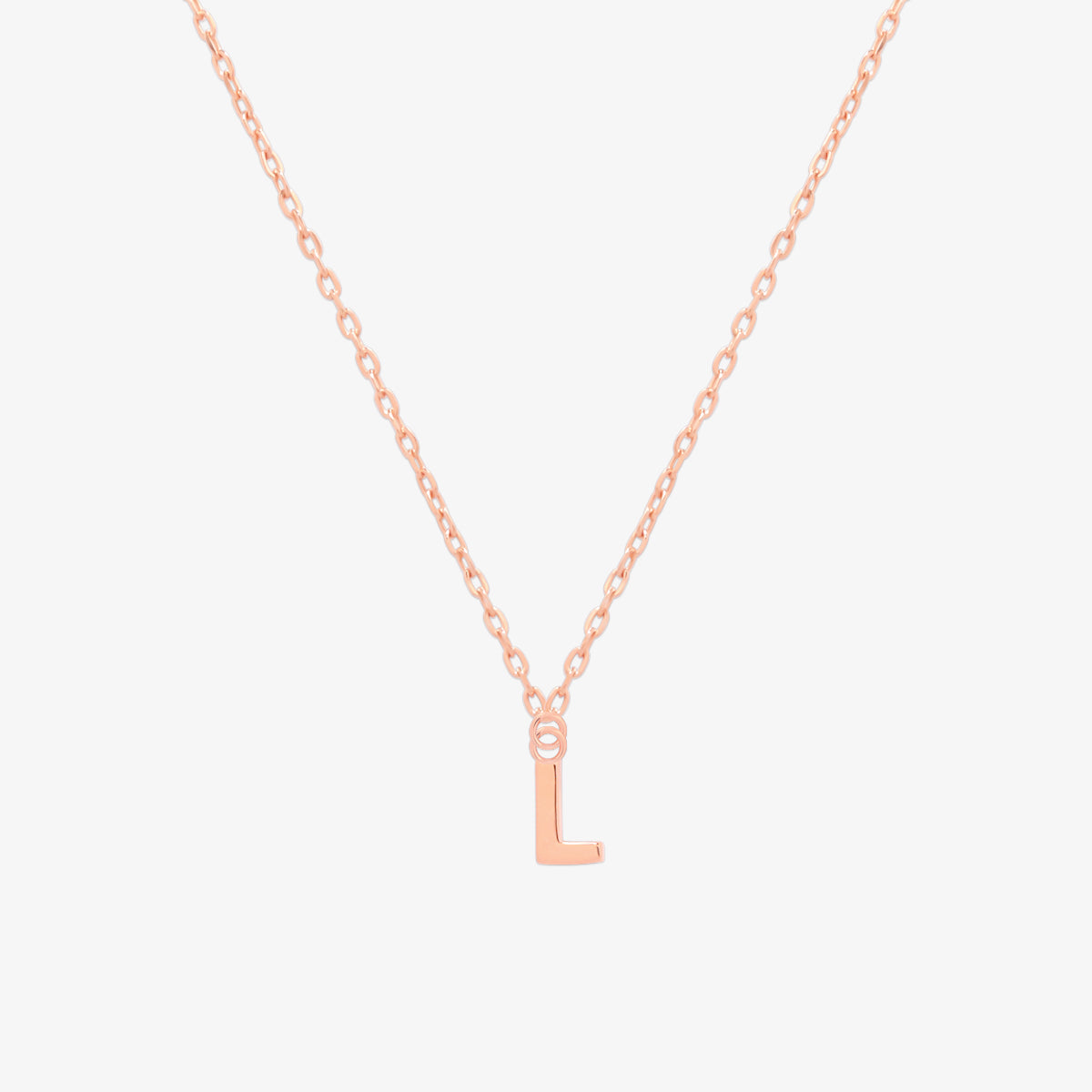 Classic initial pendant necklace featuring a polished letter charm on a delicate chain, showcasing a timeless and elegant design.